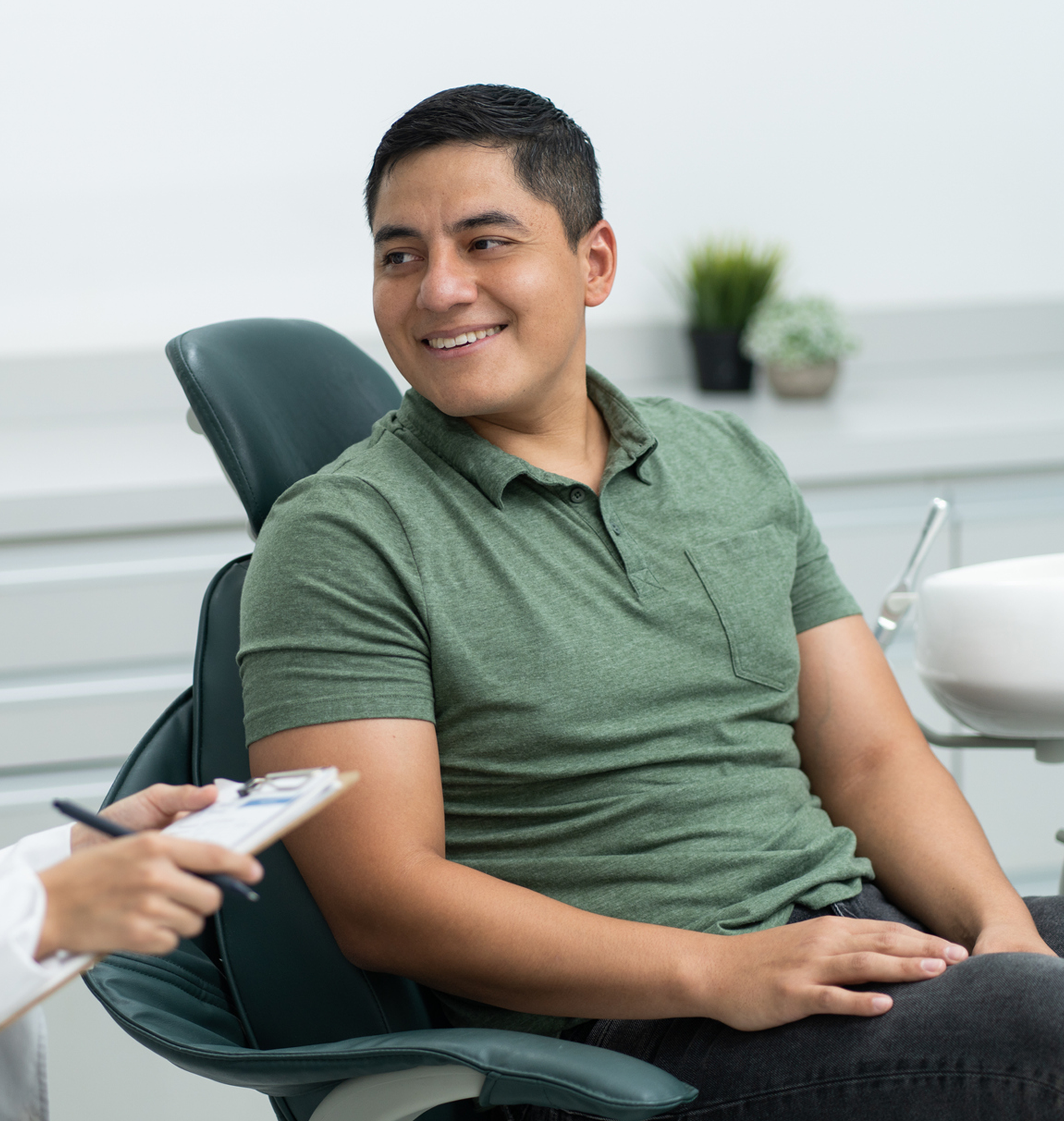 Patient consulting with a provider in a dental treatment room.